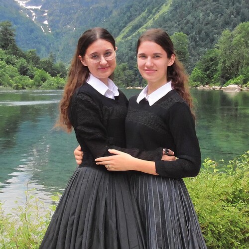 Firefly two Israeli girls, without glasses, with blue eyes, hair in ponytails, wearing black sweater (2)