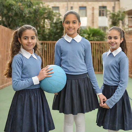 Firefly a class of young Israeli girls, playing ball, smiling, blond hair pulled back in a low pony
